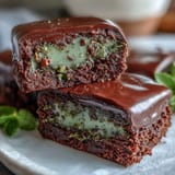 Festive St. Patricks Day Mint Chocolate Chip Brownie Bites with green swirls and chocolate chunks.  