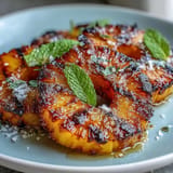 Caramelized pineapple rings with vibrant green yuzu kosho butter, ready to serve.