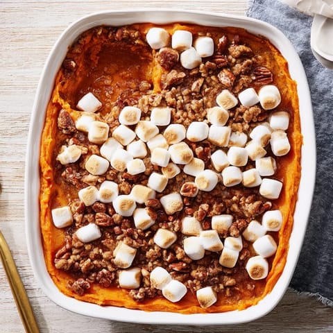 Baked Sweet Potato Casserole with a crunchy, buttery pecan streusel topping and sweet orange flesh.