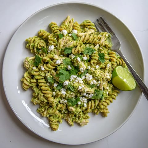Freshly tossed Cilantro Lime Chicken Pasta with creamy green sauce and tender chicken, ready to serve.