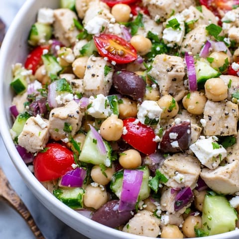 Fresh Mediterranean Chickpea Chicken Salad featuring crisp cucumber, cherry tomatoes, and parsley tossed in a zesty lemon dressing.  