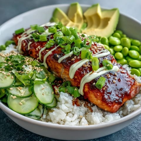 Pan-fried salmon fillets glazed in sticky honey sriracha, nestled on jasmine rice with avocado, cucumber, and edamame.